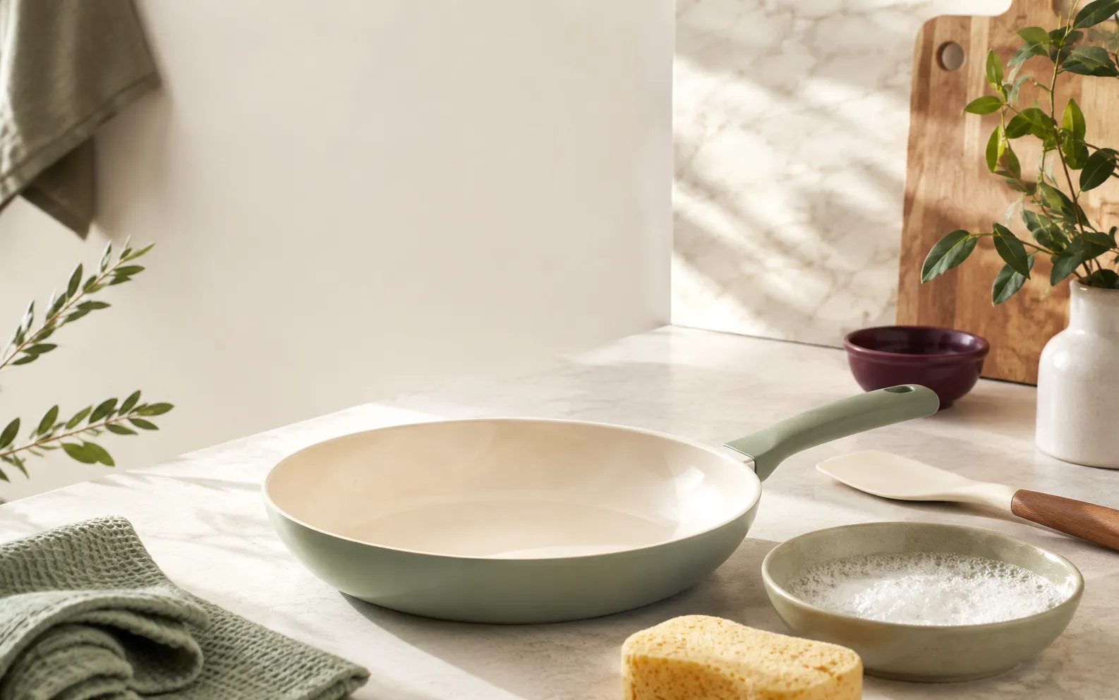 Ceramic nonstick skillet on a stovetop at a moderate heat setting