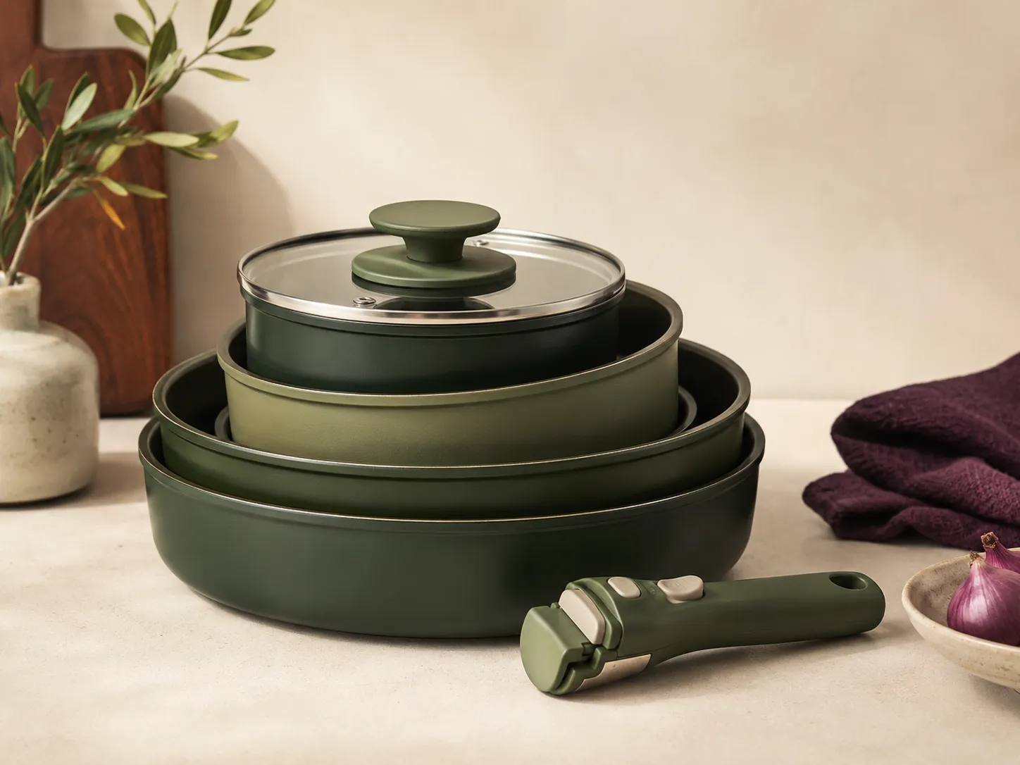 Removable-handle cookware set stacked neatly in a small kitchen cabinet